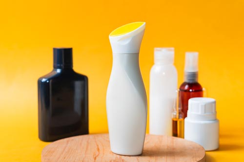 stylish cosmetic bottles on yellow background 2024 10 15 04 17 26 utc